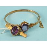 A 9ct gold hinged bangle, collet set an oval amethyst with cannetile decoration, 7.6g and a