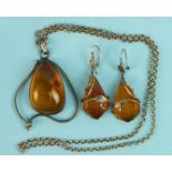 An amber pendant with silver mount on belcher link chain and a pair of amber drop earrings with