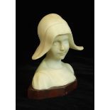 An early-20th century alabaster figure of a Dutch girl wearing a bonnet, raised on a marble base,