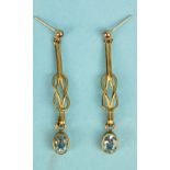 A pair of aquamarine drop earrings, the collet set aquamarines on 9ct gold love knot mounts, 4.5cm