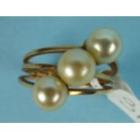 WITHDRAWN An 18ct gold dress ring of three bands, each set with a cultured pearl, size O, 7.1g.