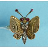 An unusual 18ct gold ring in the form of a butterfly with diamond set body, ruby set eyes and