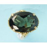 An 18ct gold ring claw set a large green spinel, size M, 8g.