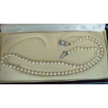 A string of Mikimoto uniform cultured pearls with silver clasp stamped "M", in original box with