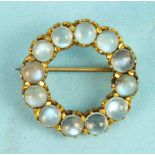 A moonstone circlet brooch, claw set twelve round moonstones in unmarked mount.