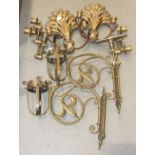 A collection of metal candle holders, including two pairs of brass wall-mounted fittings.