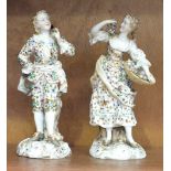 A pair of early-20th century Continental figurines; a young man holding a flower and a young girl