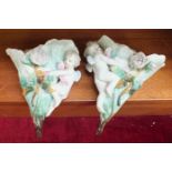 A pair of KPM porcelain wall pockets with applied cherub and floral decoration, 19cm high, (2).