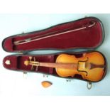 A miniature violin, 22.5cm long with bow and chin rest, in case.