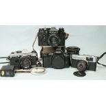 Four various SLR cameras: Pentax MZ-10, Olympus OM-10, with booklet, Olympus Trip 35 and Zenit