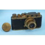 A Russian copy of a Leica camera with brass case, numbered 109264.