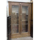 A 19th century pine glazed two-door bookcase, 132cm wide, 202cm high.