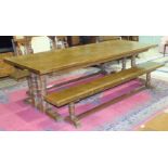 A large modern oak refectory dining table, the rectangular top on turned end supports joined by a