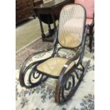 A small bentwood caned-seat-and-back rocking chair.