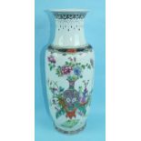 A Chinese porcelain rouleau vase decorated with a large vase of flowers in famille rose enamels