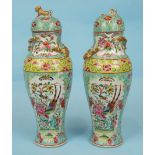 A pair of 19th century Chinese famille rose porcelain vases and covers painted with exotic birds and