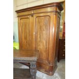 A Continental walnut two-door hanging wardrobe, the cornice above two panelled doors and two base