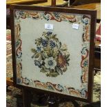 A 19th century rosewood pole screen, the square needlework panel on a turned column and circular