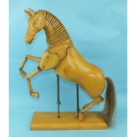 A modern carved wood articulated model of a horse with reticulated neck, jointed limbs and horse