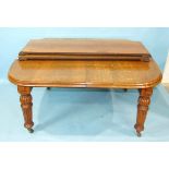 A large Victorian oak extending dining table, the top with moulded edge, on carved and reeded