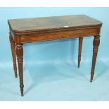 An early-19th century rosewood card table, the fold-over top with beaded border, on turned tapered