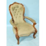 A Victorian walnut button-back salon chair with carved frame and serpentine seat, on carved cabriole