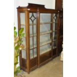 An Edwardian mahogany inlaid display cabinet having a central glazed door enclosing four shelves, on