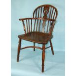 A 19th century yew wood stick-back Windsor armchair, with elm seat and back legs joined by a