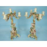 A pair of 19th century Continental porcelain four-branch candelabra formed as tripod bases