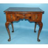 An 18th century walnut low boy, the later top above three frieze drawers, on cabriole legs with