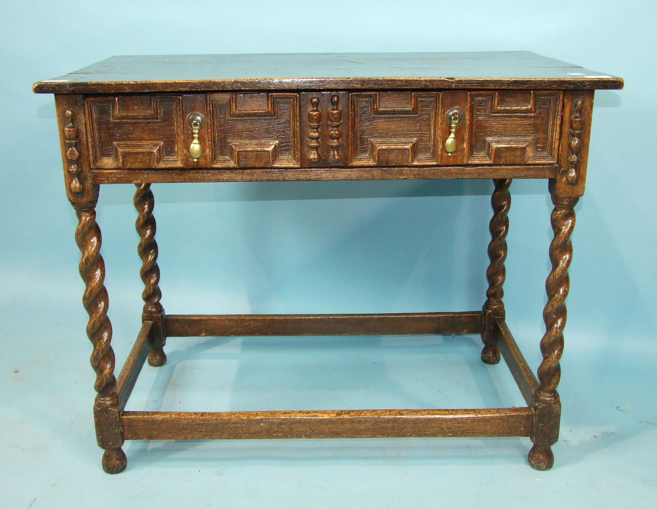 An antique oak rectangular side table in the 17th century style, having a single frieze drawer, on