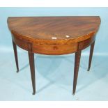 A Georgian mahogany tea table, the circular fold-over top above a frieze drawer, on square tapered