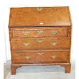 A Georgian burr walnut and rosewood-banded bureau, the fall front and fitted interior above three