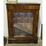 A Victorian walnut rectangular dwarf bookcase having a single glazed door, raised on a plinth,