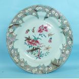 A large 18th century Chinese famille rose porcelain charger decorated with a large floral bouquet to