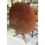 A Georgian mahogany tilt-top breakfast table, the circular top and bird-cage action on turned column