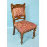 A set of six Victorian oak dining chairs, each with padded back and seat and turned and reeded front