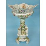 A large 19th century German porcelain centrepiece formed as a pierced floral-encrusted basket