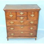 An antique oak small chest of four short and three long drawers, the frame extended to form feet,