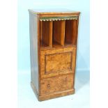 A Victorian walnut music cabinet, the rectangular top above pigeon holes, a cupboard door and deep