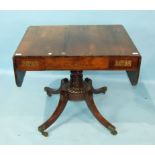 A Regency sofa table, the rectangular top with two drop leaves inlaid with brass lines and star