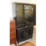 A Victorian ebonised display cabinet, the galleried top above a single glazed door and two