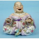 A 19th century Continental porcelain figure of a nodding Chinaman with floral printed decoration and