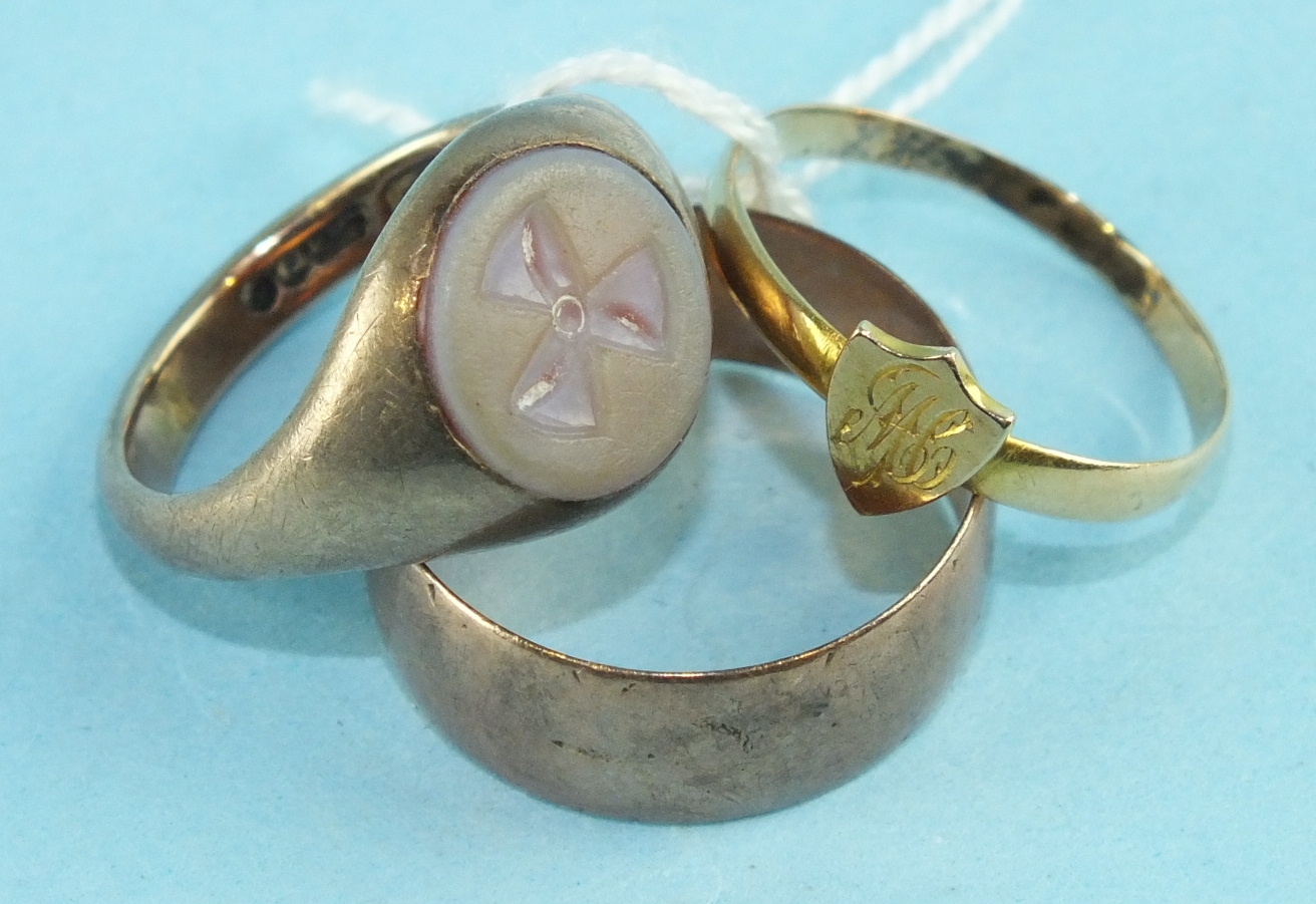 A 9ct gold signet ring set a hard stone cameo with propeller motif, size N, a small 18ct gold ring