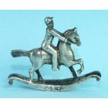 A small silver model of a rocking horse and rider, some marks rubbed, London import marks for