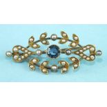 An Edwardian brooch of elliptical marquise shape set seed pearls around a collet-set sapphire, in