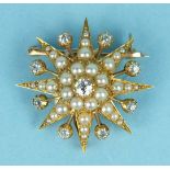 A Victorian star brooch/pendant centrally-set an old brilliant-cut diamond, within a cluster of