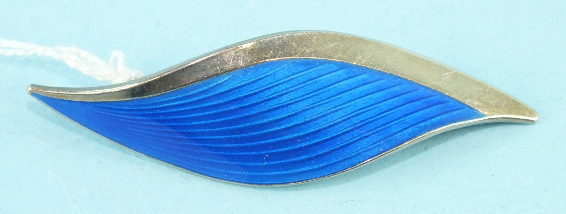 A blue enamelled Norwegian silver brooch in the form of a leaf by Albert Scharning, signed 'A Sch'.