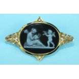 A Victorian brooch set an oval hard stone cameo depicting a classical scene of winged goddess and