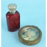 A small yellow metal compact, the lid inset a portrait of an 18th century lady and a small red glass